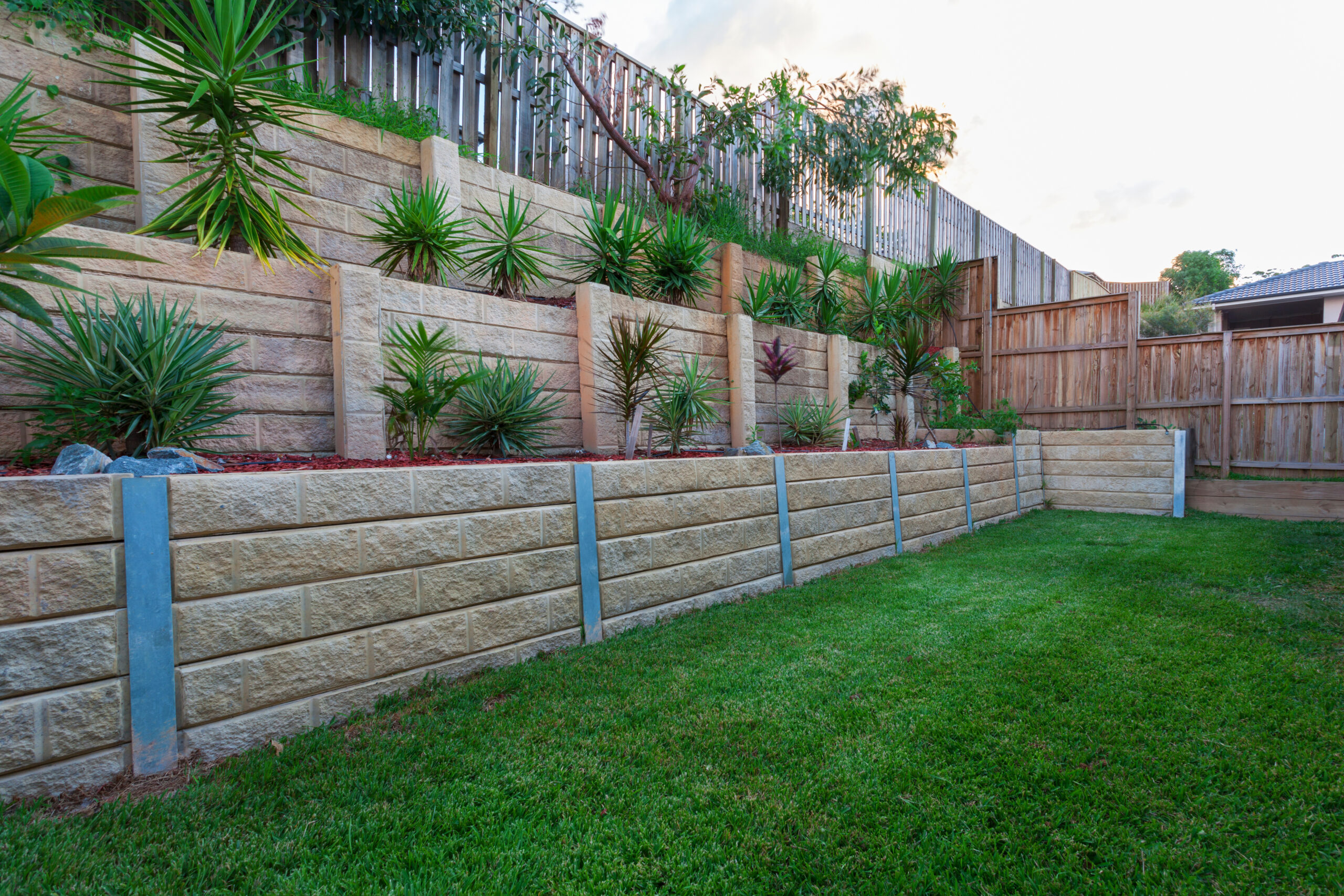 Engineered stone retaining wall built by D & M Landscape in Wellesley area